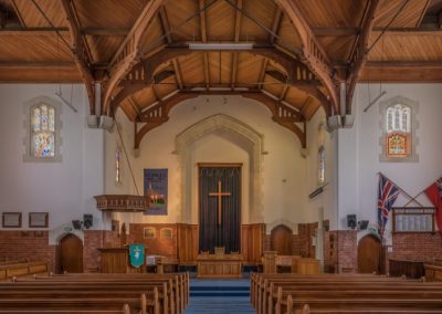 St Paul's church interior with timber-trussed ceiling, pulpit and cross