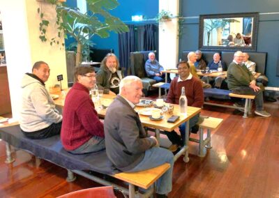 Men's breakfast group gathered around a table